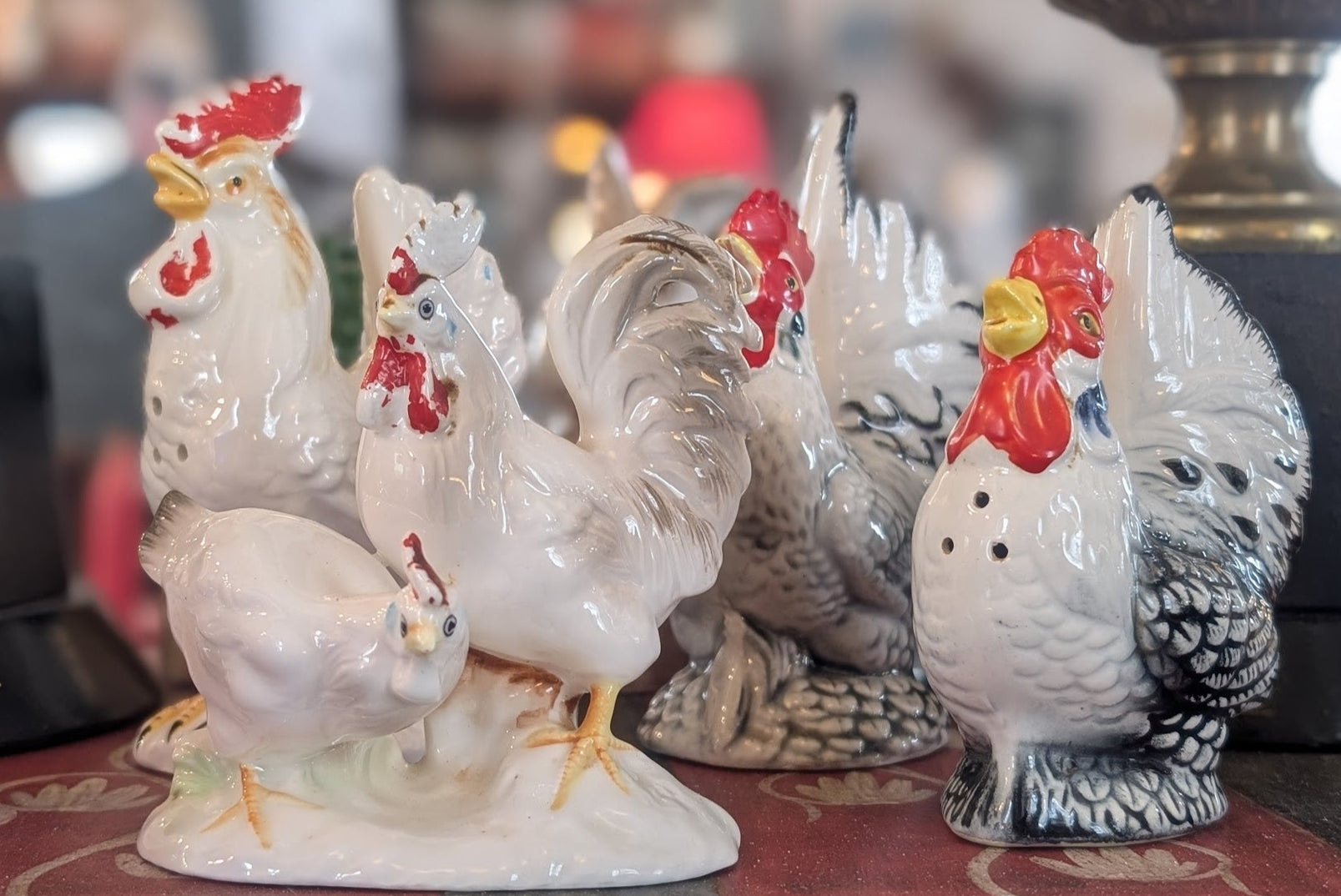 A set of vintage ceramic hens and roosters on a table