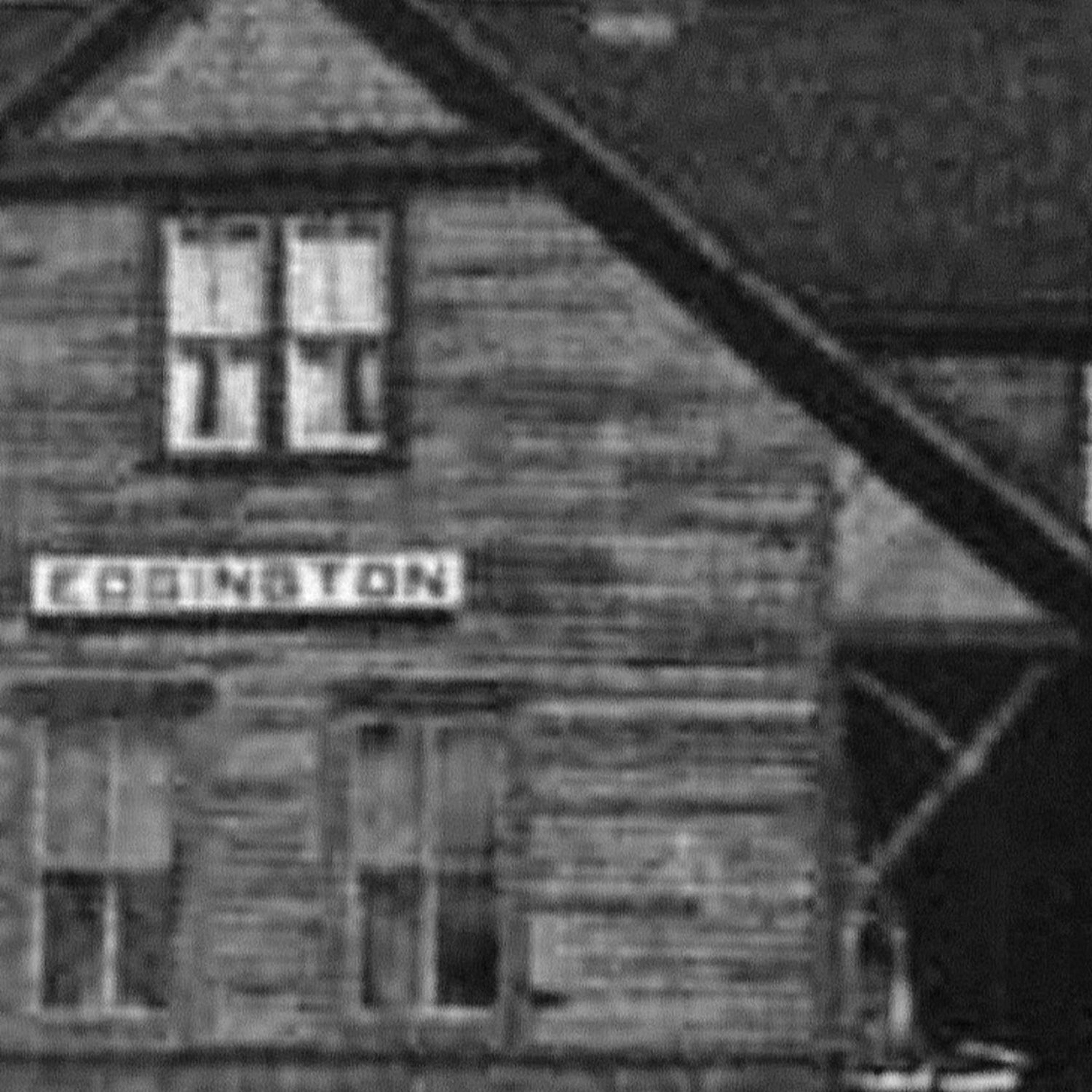 An old and grainy black and white photo of the Edgington Train Station
