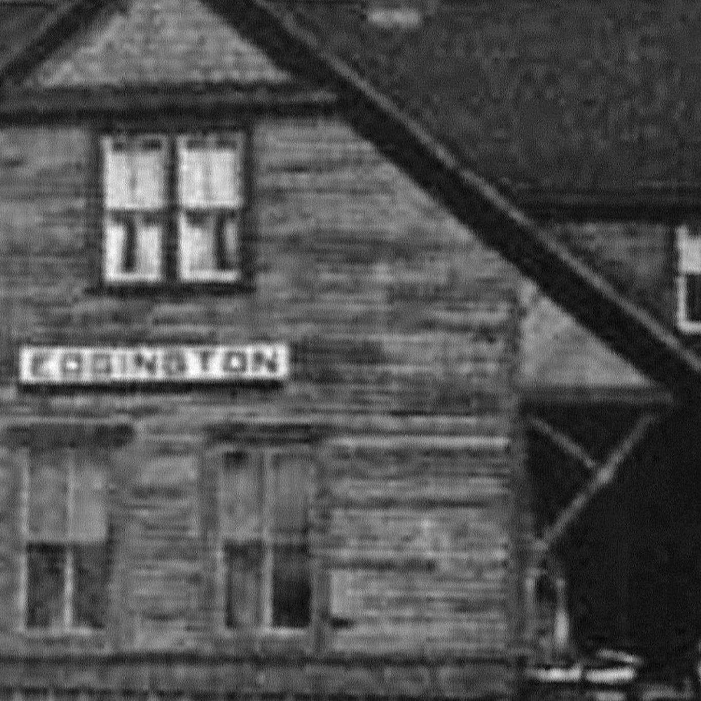 An old and grainy black and white photo of the Edgington Train Station