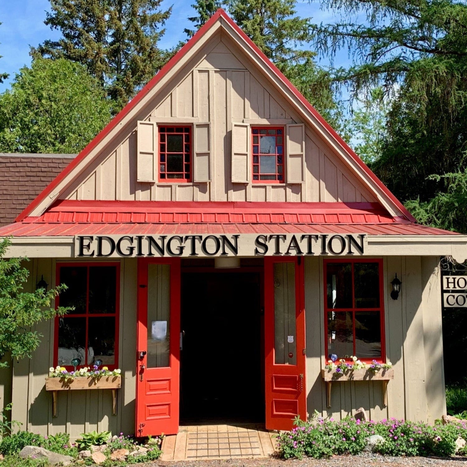 The front of the shop with the doors open on a sunny summer day