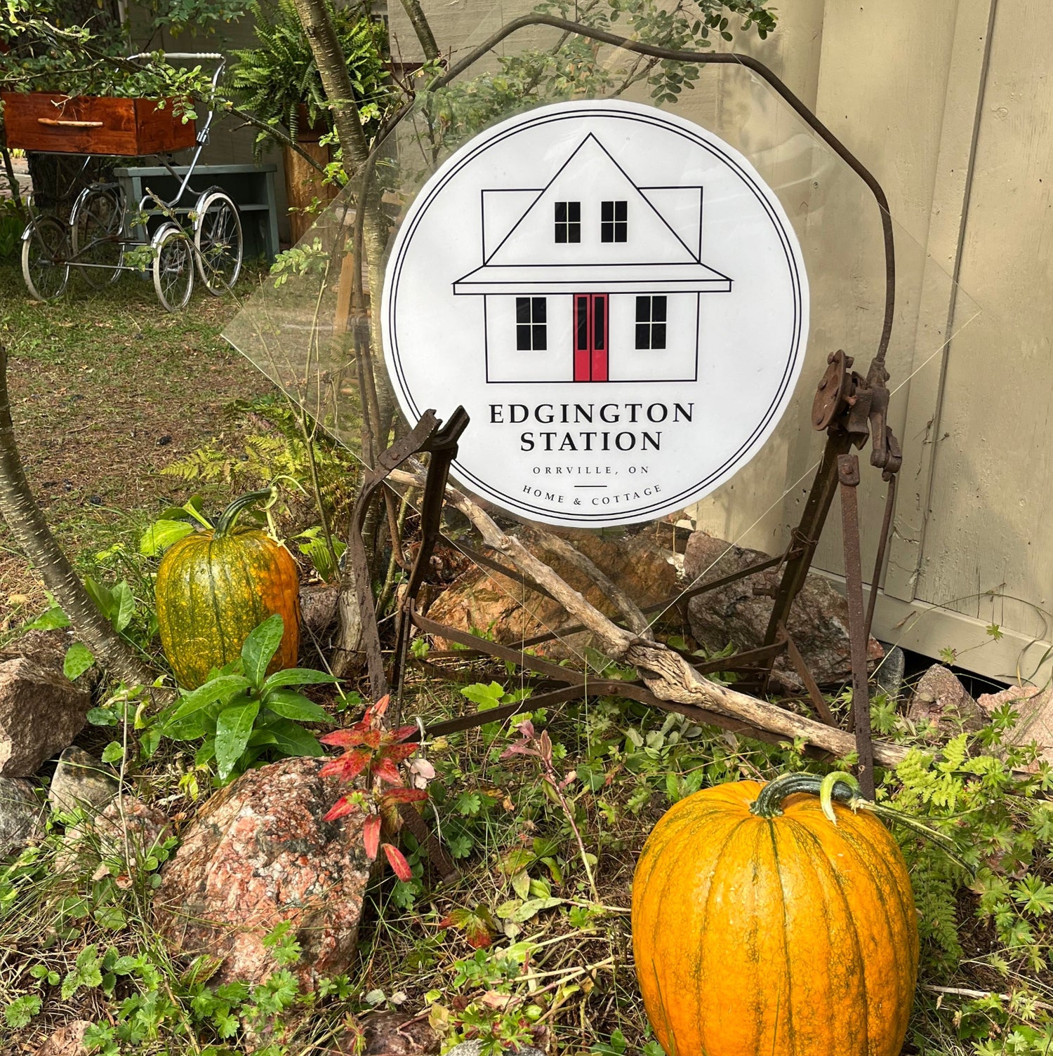 The Edgington Station logo perched in the fall garden