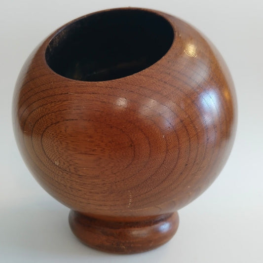 Footed wooden bowl with a smooth finish on a white background