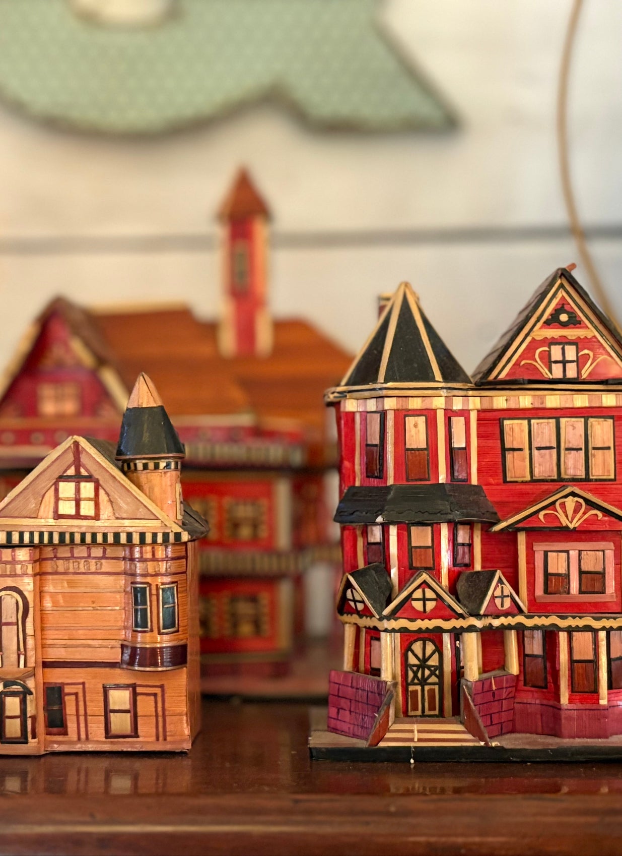 a collection of miniature ornamental houses crafted from wood